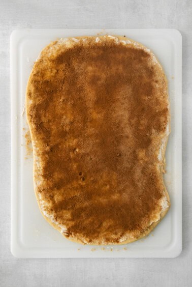 a piece of bread on a white cutting board.