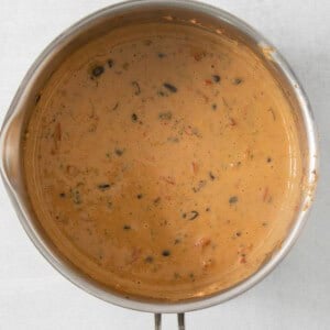 a pot of soup sitting on top of a stove.