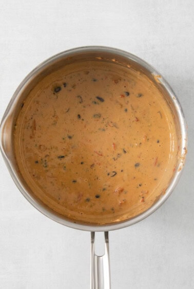 a pot of soup sitting on top of a stove.