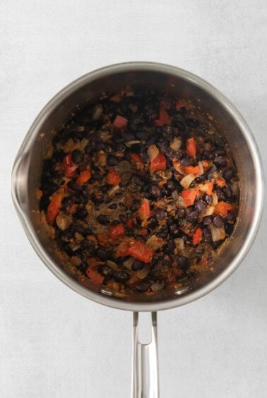 a pot filled with lots of food on top of a stove.