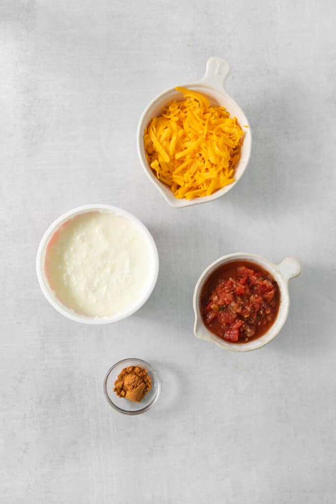three bowls with cheese, salsa, and sour cream.