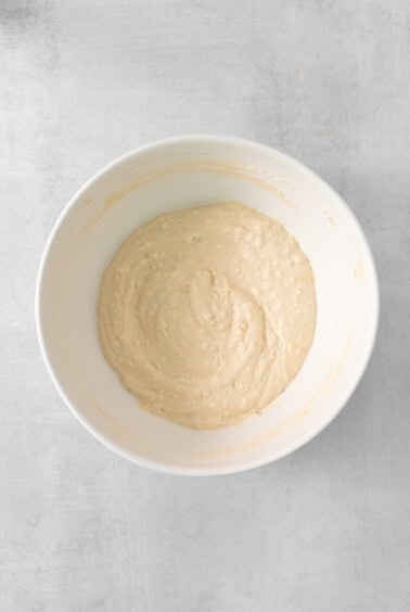 a white bowl with a mixture in it.