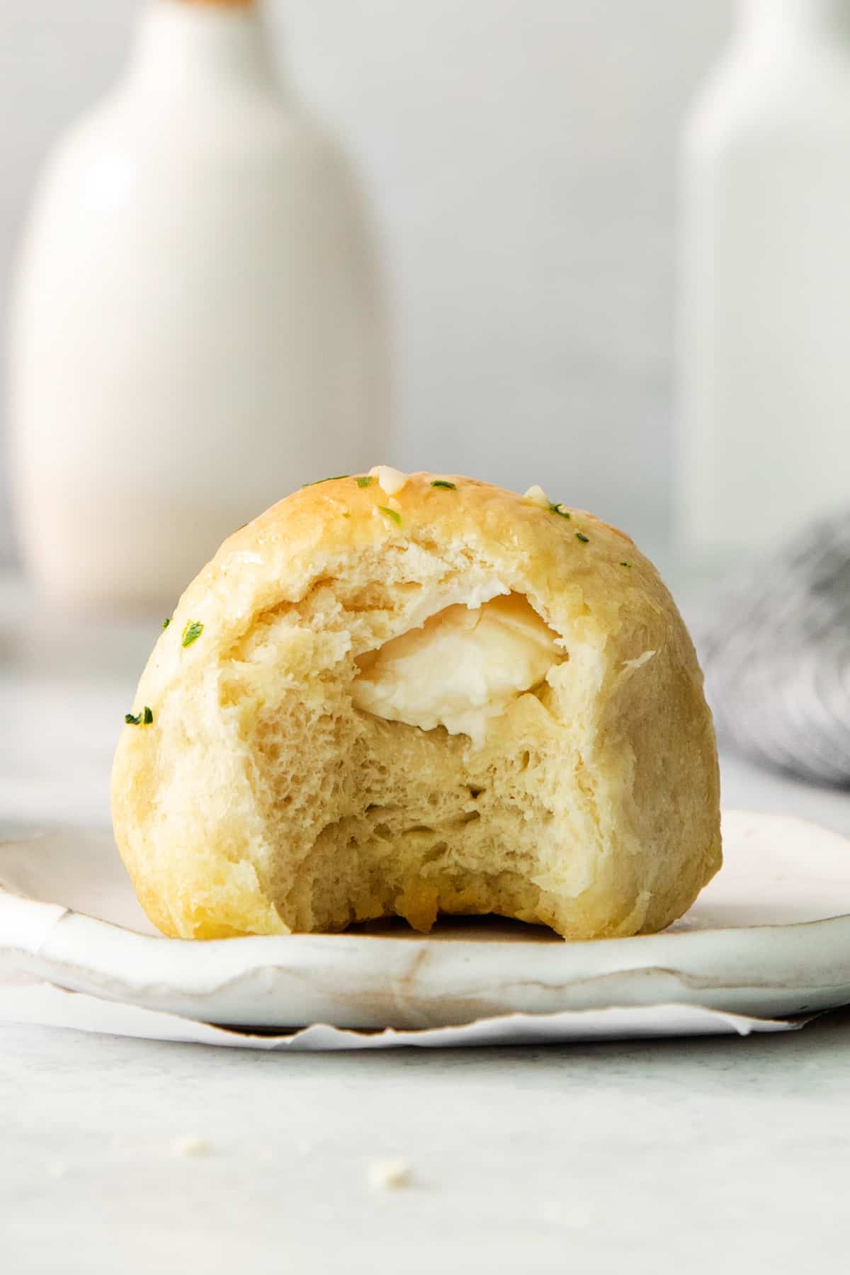 a loaf of bread on a plate with a bite taken out of it.