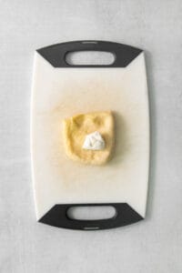 a piece of dough on a cutting board.