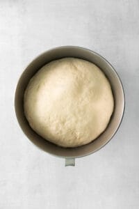 a loaf of bread in a metal pan on a white background.