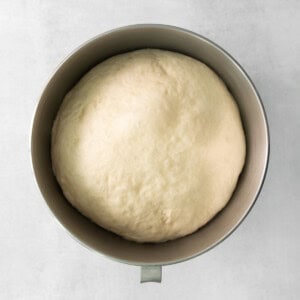 a loaf of bread in a metal pan on a white background.