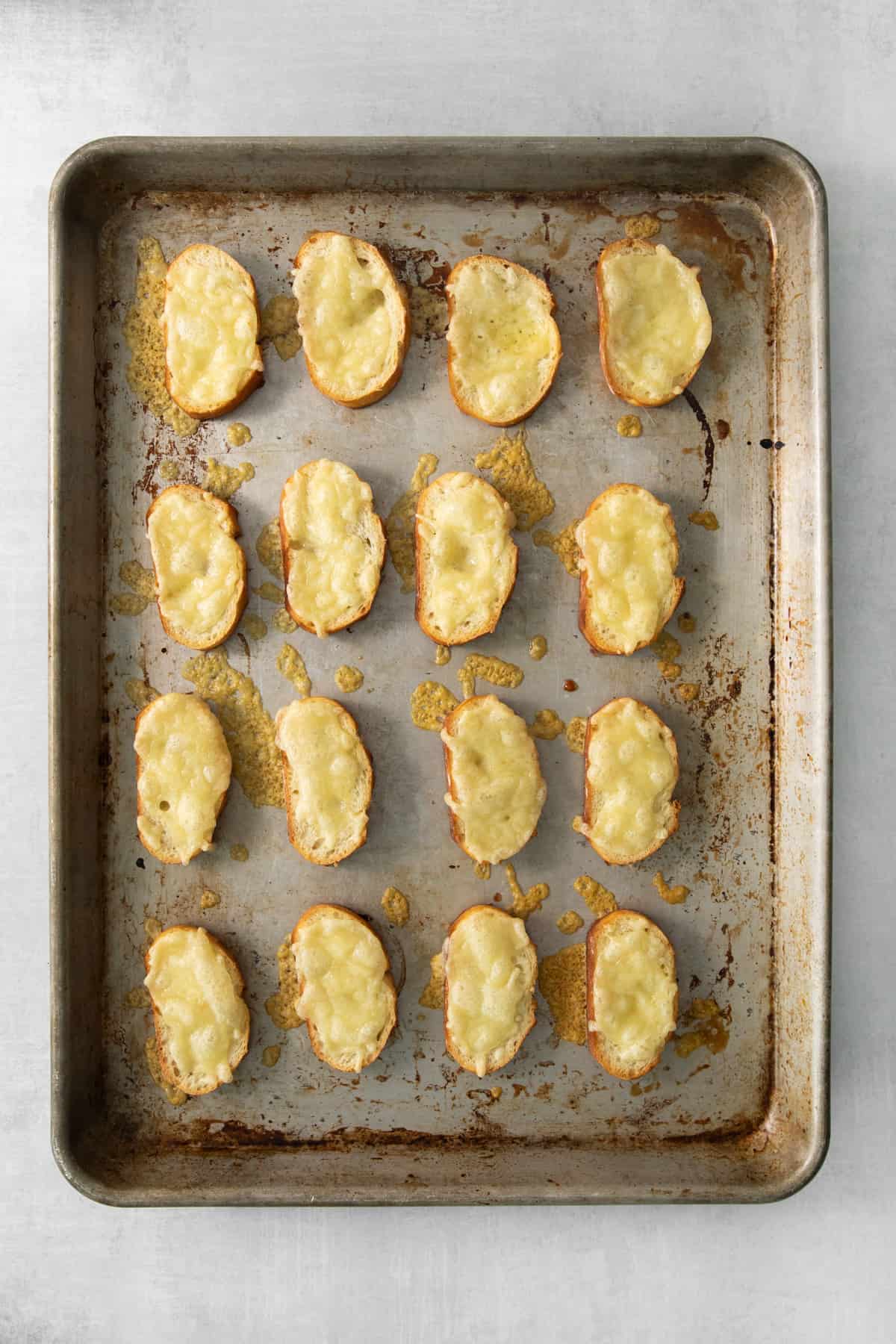 cheesy croutons on a baking sheet.