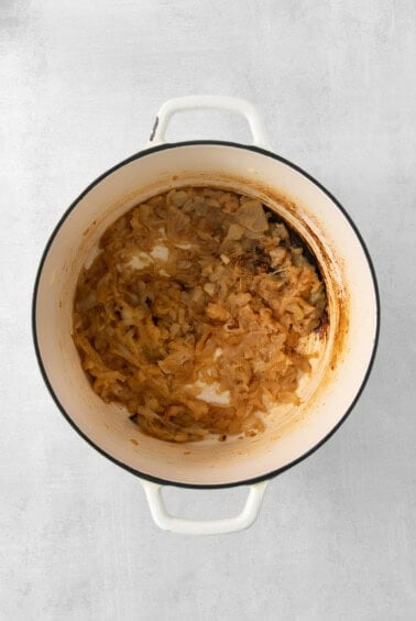 onion soup in a white pot on a white background.