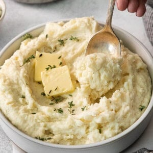 Mashed potatoes in a bowl with a spoon.