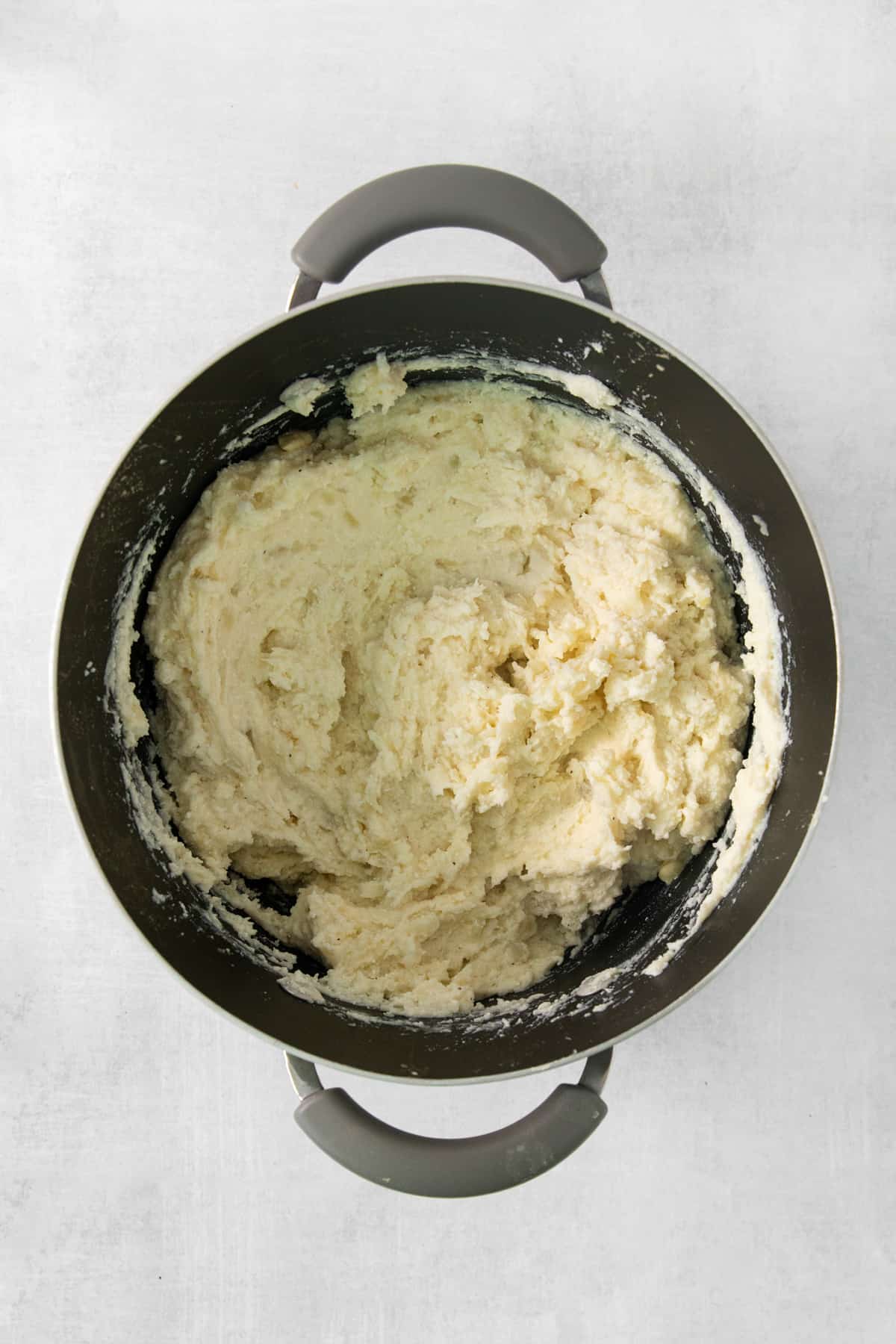 Mashed potatoes in a pan on a white background.