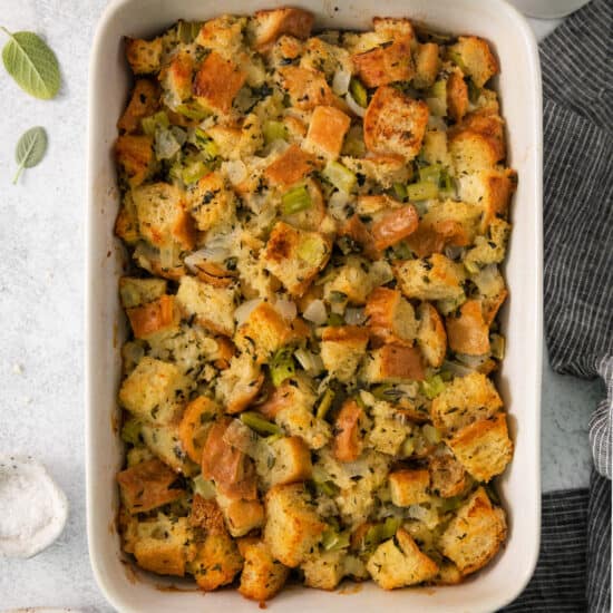 Bread stuffing in a white dish on a table.