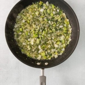 A frying pan with vegetables in it.