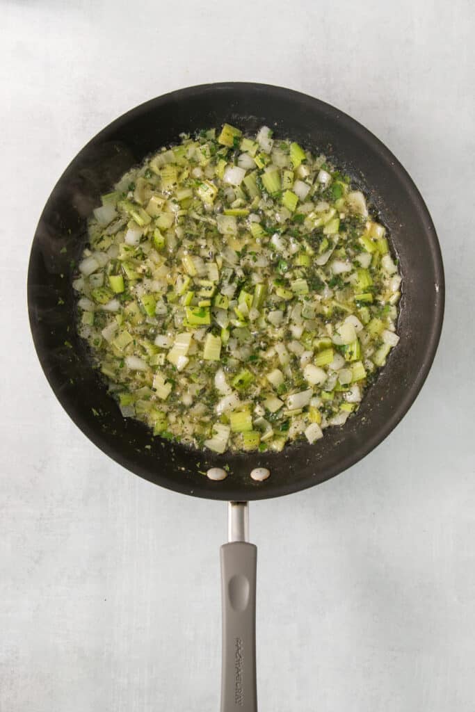 A frying pan with vegetables in it.