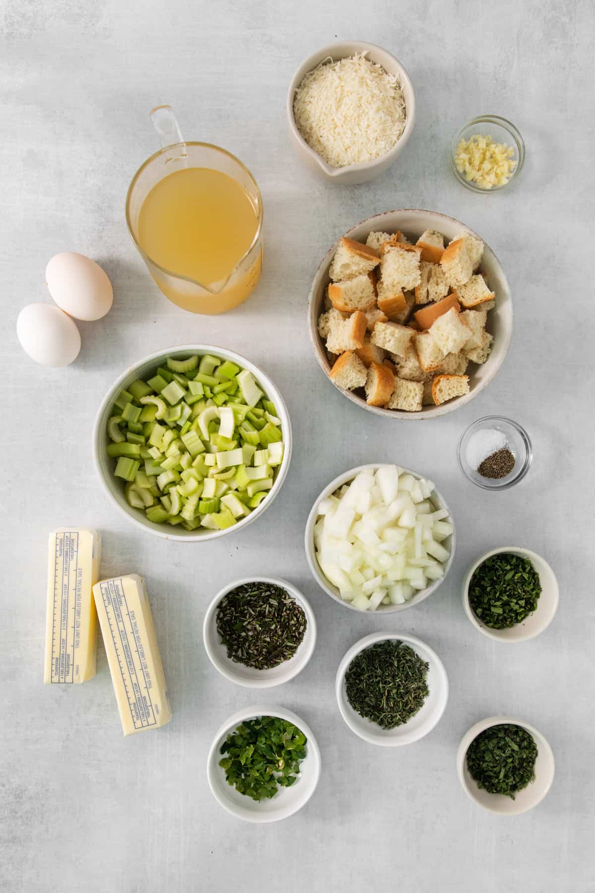 The ingredients for a cheesy croutons recipe on a grey background.