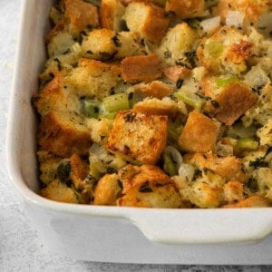 Thanksgiving stuffing in a white baking dish.