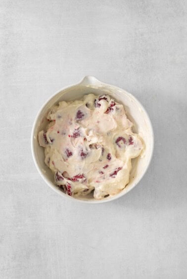 cranberry ice cream in a white bowl.