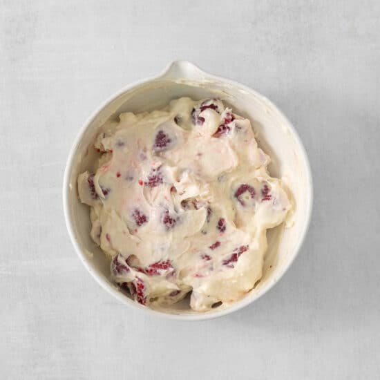 cranberry ice cream in a white bowl.