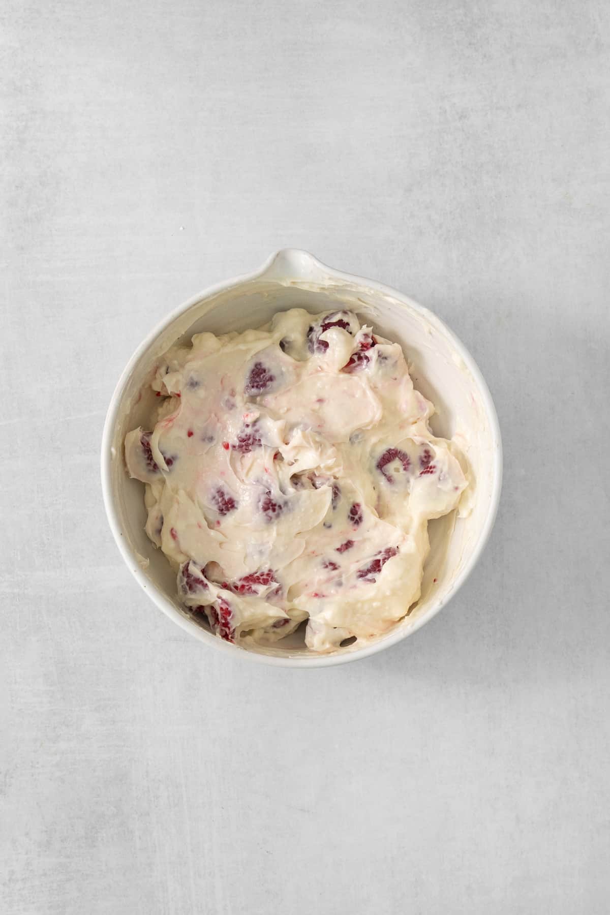 cranberry ice cream in a white bowl.