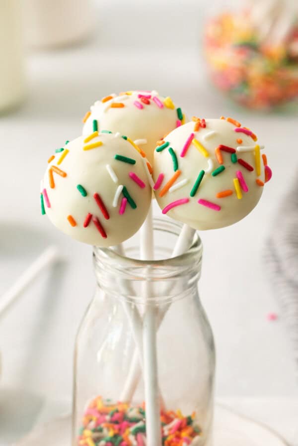 cake pops with sprinkles in a glass jar.