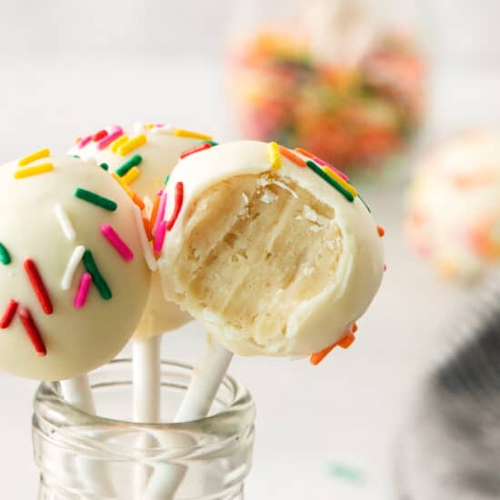 cake pops with sprinkles on a stick.