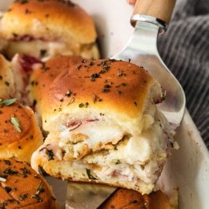 Ham and cheese sliders in a baking dish.