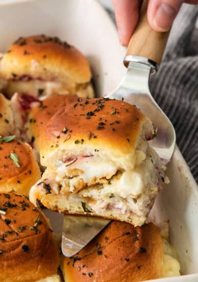 Ham and cheese sliders in a baking dish.
