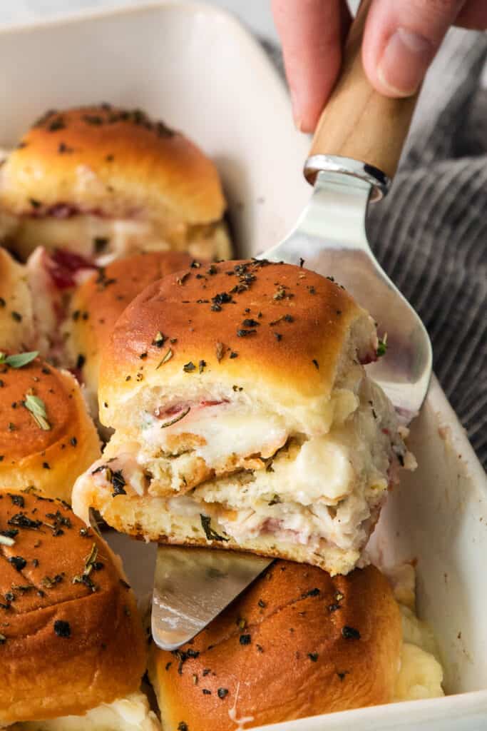 Ham and cheese sliders in a baking dish.
