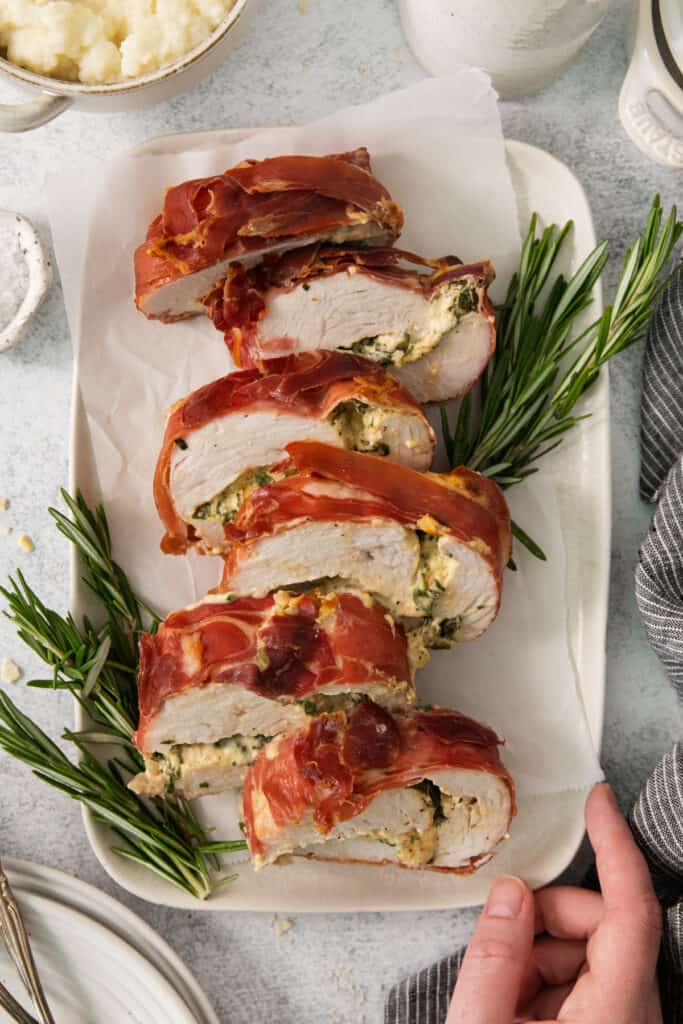 A plate of bacon wrapped chicken with sage and rosemary.