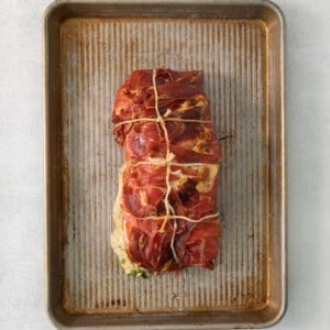 A piece of meat on a baking sheet.