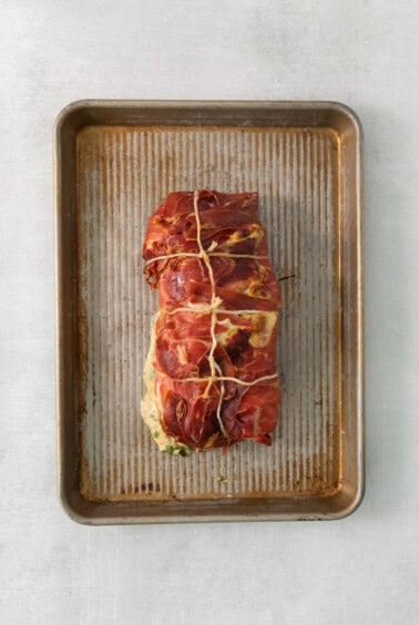A piece of meat on a baking sheet.