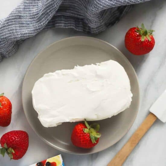 A plate with cream cheese and strawberries, alongside a guide on how to soften the cream cheese.