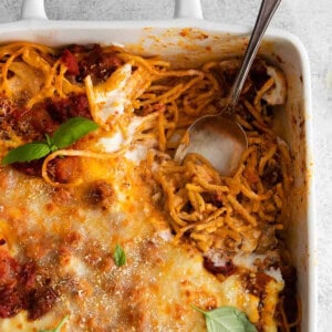 A casserole dish filled with spaghetti and meatballs.