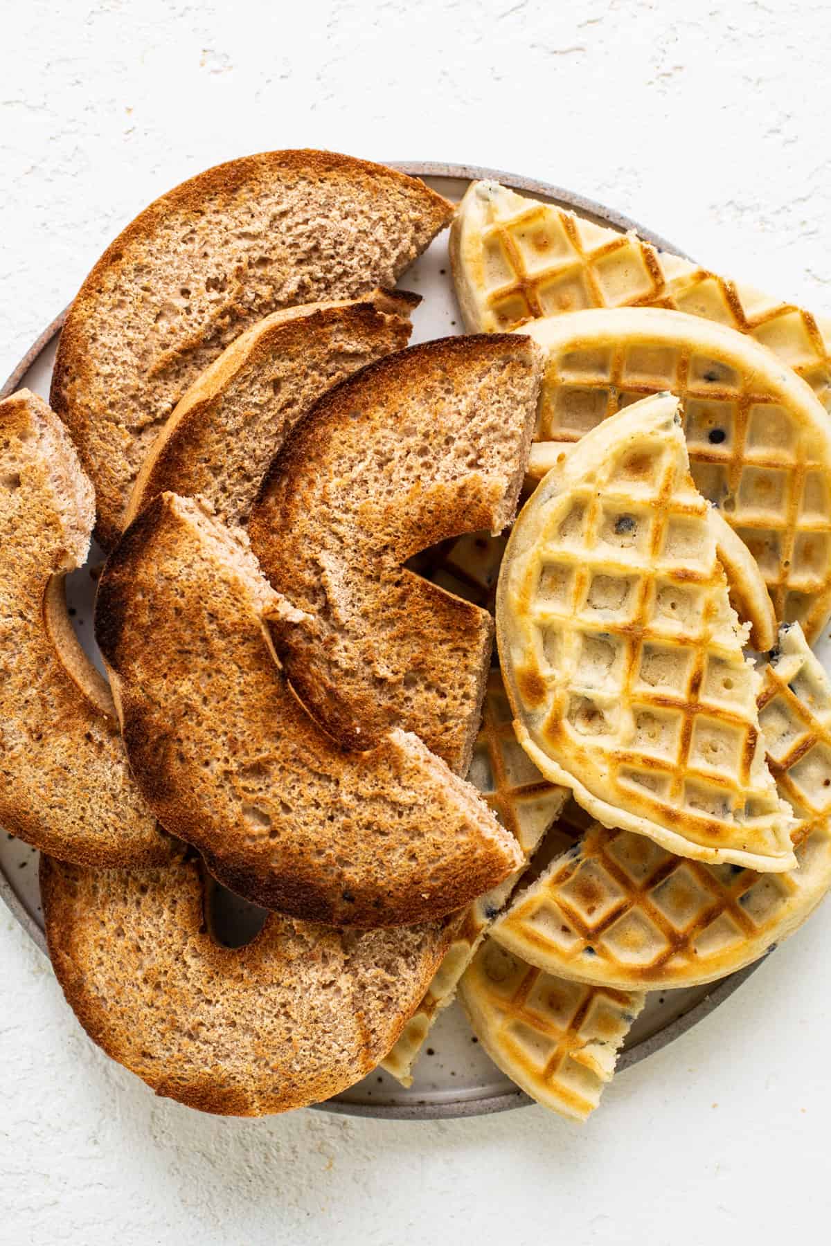 Waffles on a plate on a white background.