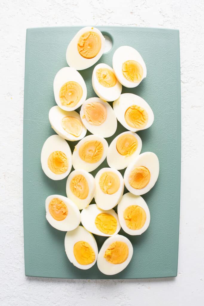 Hard boiled eggs on a cutting board.