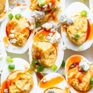Deviled eggs topped with blue cheese and green onions.