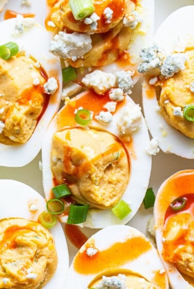 Deviled eggs topped with blue cheese and green onions.