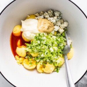 A bowl filled with vegetables and a fork.