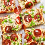 Pepperoni pizza with peppers and green onions.