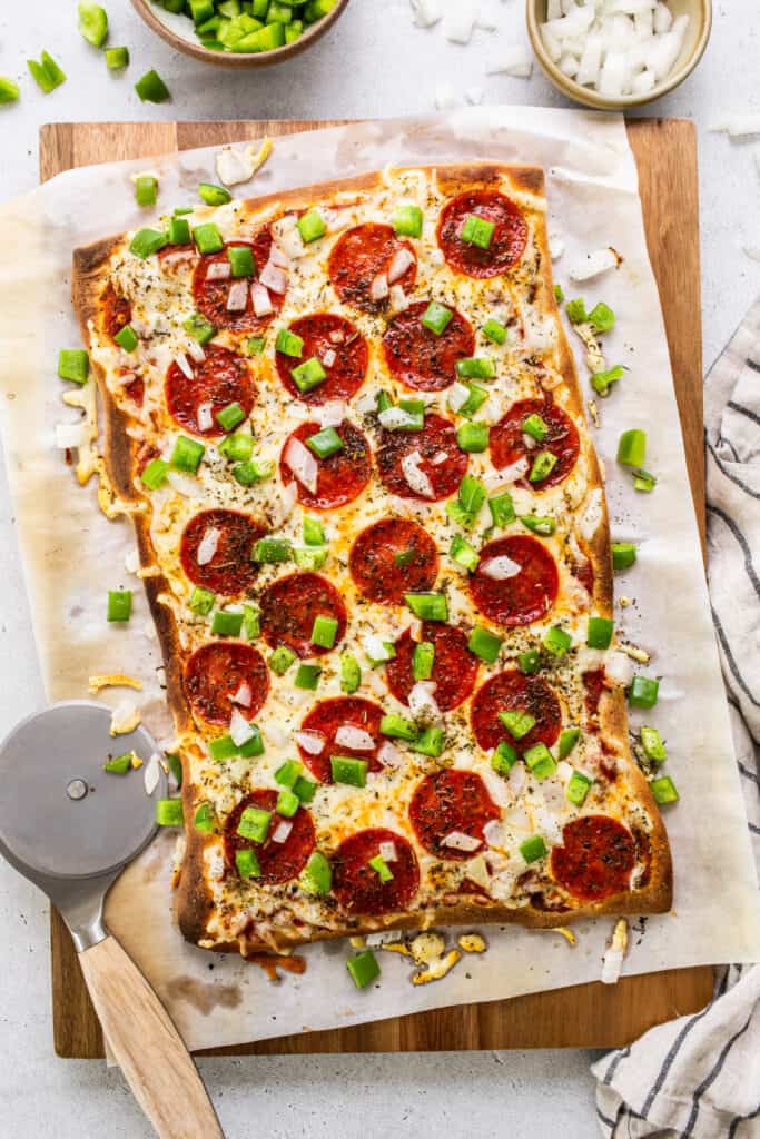 Pepperoni pizza on a cutting board.