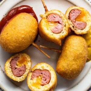 A plate with meatballs and ketchup on it.