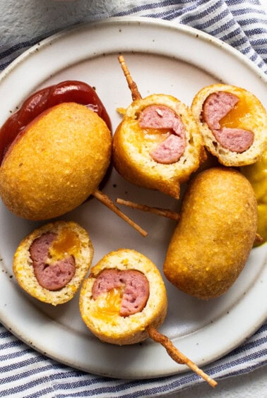 A plate with meatballs and ketchup on it.