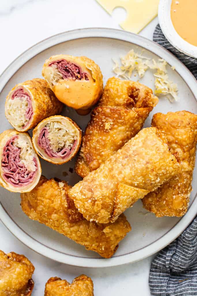 Chinese spring rolls on a plate with dipping sauce.