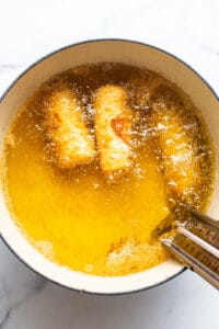 A bowl of food in a pan with a spoon in it.