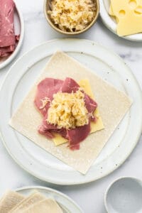 A plate with meat and cheese on it.