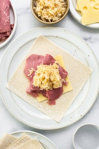 A plate with meat and cheese on it.