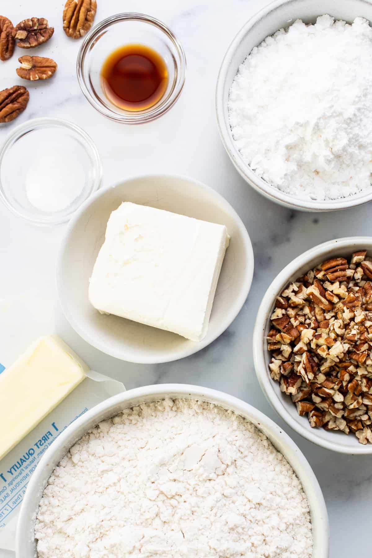 A bowl of flour, sugar, butter and pecans.