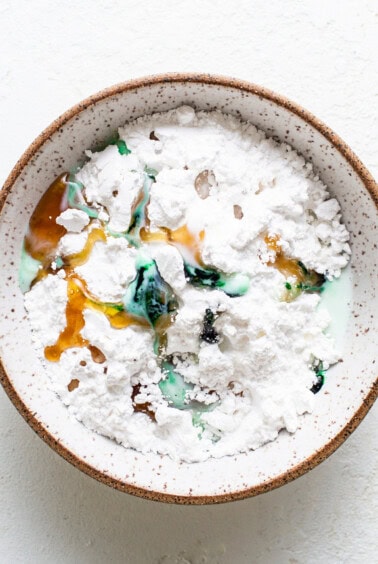 A bowl filled with a mixture of flour and sugar.