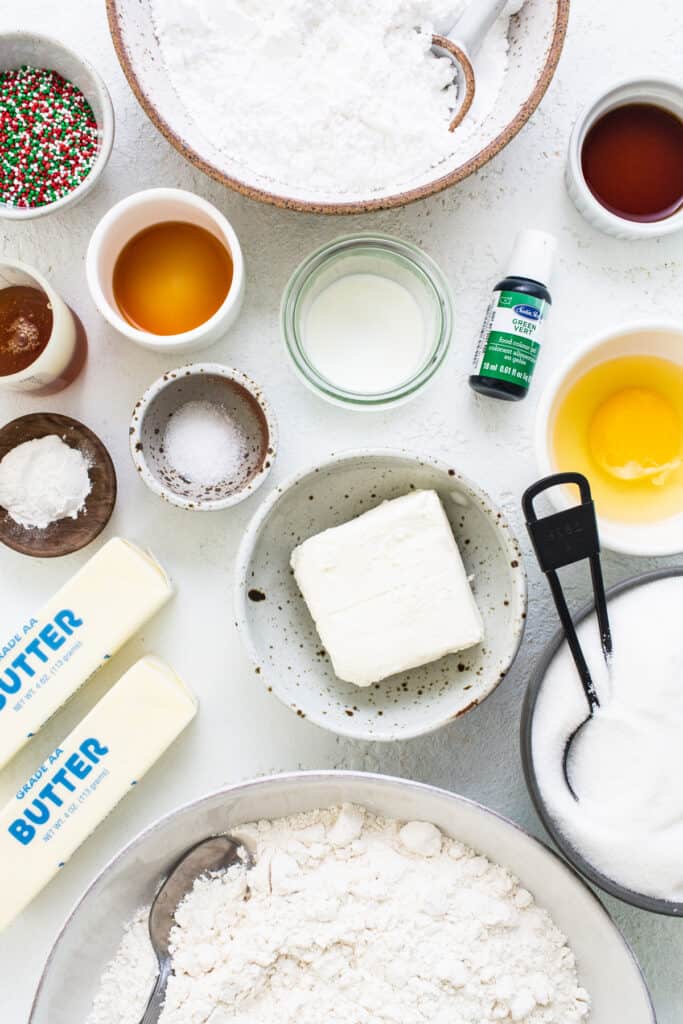A white table with ingredients for a cookie recipe.
