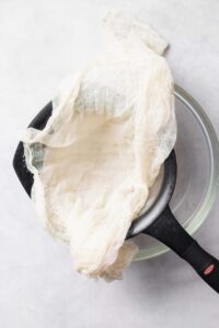A pan with a ricotta-filled cloth.