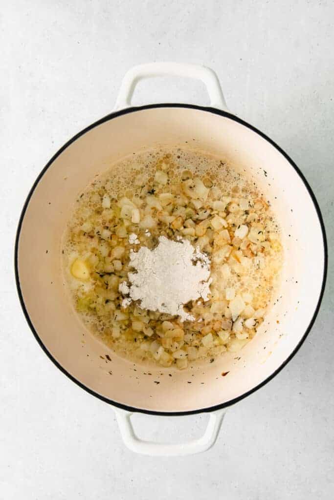 potatoes and onions sauteeing in a stock pot.